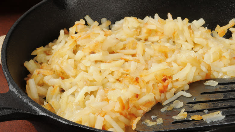 hash browns frying in pan