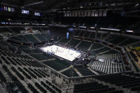 FILE - In this March 12, 2020, file photo, the seating area at Bankers Life Fieldhouse is viewed in Indianapolis after the Big Ten Conference announced that remainder of the men's NCAA college basketball games tournament was canceled. Indianapolis city leaders want the college basketball world to know it is open for business. On Friday, Sept. 18, 2020, Indiana Sports Corp, a local, year-round organizing committee, publicly released a 16-page proposal to convert convert about half of the city convention center's exhibition halls and meeting rooms into basketball courts and locker rooms, providing expansive safety measures and daily COVID-19 testing. (AP Photo/Michael Conroy, File)