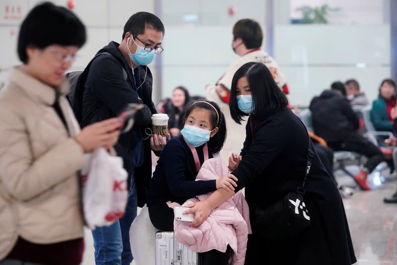 Passengers wearing masks are seen at Hongqiao International Airport in Shanghai