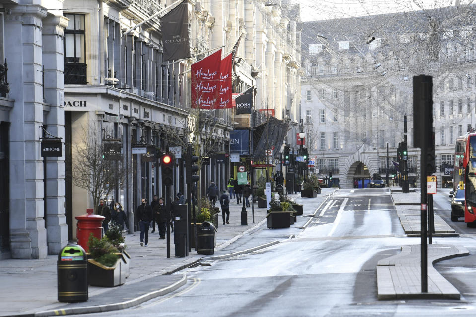 A view of part of Regent Street after Britian's Prime Ministr Boris Johnson introduced Tier 4 restrictions for London and the south east of the country, in London, Sunday, Dec. 20, 2020. Millions of people in England have learned they must cancel their Christmas get-togethers and holiday shopping trips. British Prime Minister Boris Johnson said Saturday that holiday gatherings can’t go ahead and non-essential shops must close in London and much of southern England. Johnson imposed a new, higher level of coronavirus restrictions to curb sharply spreading infections in the capital and other areas. (Stefan Rousseau/PA via AP)