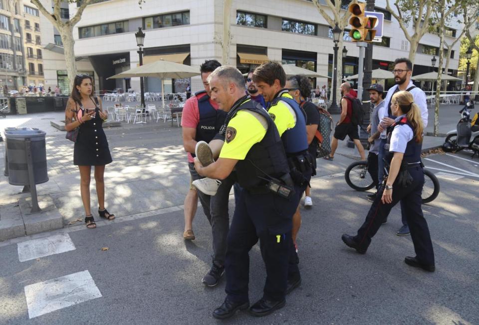 Officers treat an injured victim in Barcelona