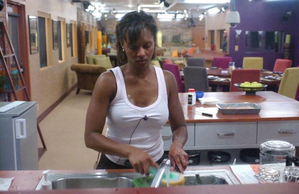 danielle reyes, a contestant on big brother 3, washes the dishes in the kitchen of the big brother house during an episode of the reality television series, studio city, los angeles, california, september 8, 2002 photo by tony esparzacbs photo archivegetty images