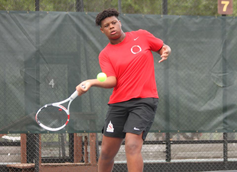 Springfield High's Noah Williams returns a shot during the Central State Eight Conference boys tennis tournament at Washington Park on Friday, May 13.