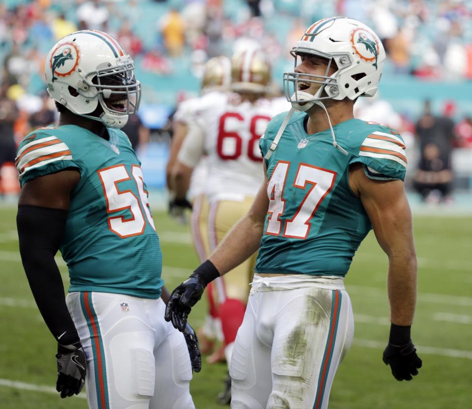 Lots to shout about: LB Kiko Alonso, shown here with teammate Donald Butler, signed an extension with the Dolphins. (AP)