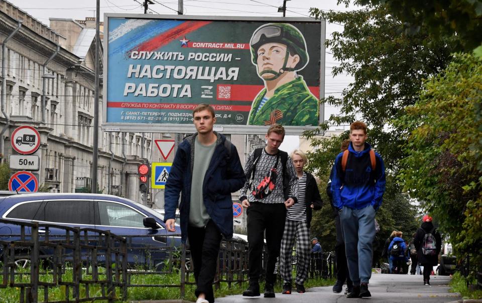 A billboard in St Petersburg calls Russian men to fight for the Russian army in Ukraine - OLGA MALTSEVA 