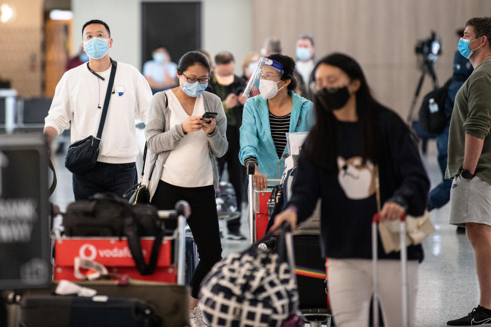 People wearing PPE arriving at Sydney International Airport in Sydney, Monday, November 29, 2021. Source: AAP