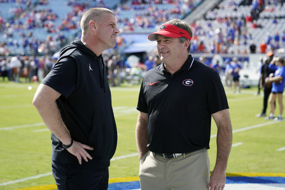 Florida head coach Billy Napier, left, and Georgia head coach Kirby Smart greet each other at midfield before an NCAA college football game, Saturday, Oct. 28, 2023, in Jacksonville, Fla. (AP Photo/John Raoux)