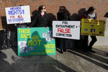 Demonstrators asserting that evidence of the Boston Marathon bombing was fabricated stand outside the federal courthouse ahead of a pre-trial conference for Boston Marathon bombing suspect Dzhokhar Tsarnaev in Boston, Massachusetts December 18, 2014. REUTERS/Brian Snyder