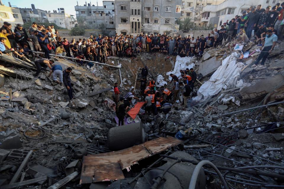 Palestinians gather over the remains of a destroyed house following Israeli airstrikes on Gaza City on Saturday (Copyright 2023 The Associated Press. All rights reserved.)