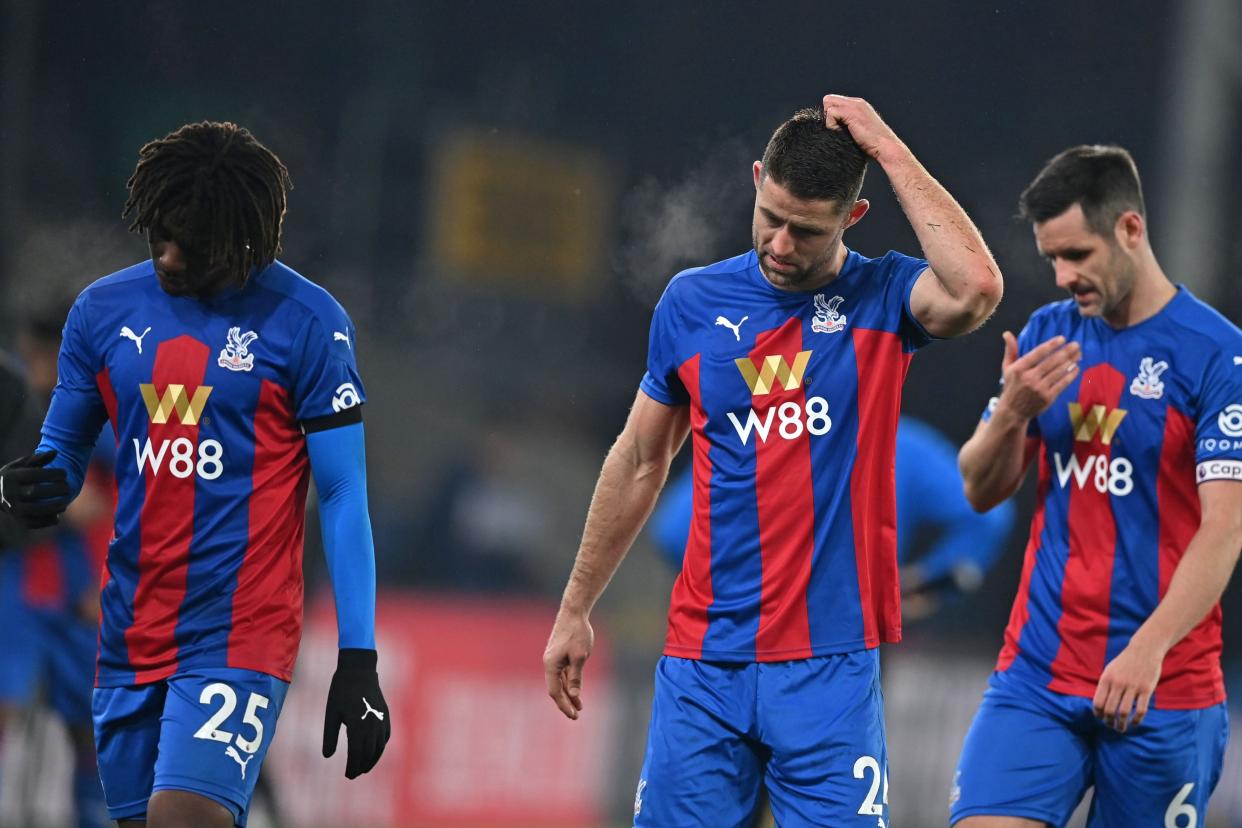 <p>Crystal Palace’s Eberechi Eze, Gary Cahill and Scott Dann look dejected after defeat at Selhurst Park</p> (POOL/AFP via Getty Images)