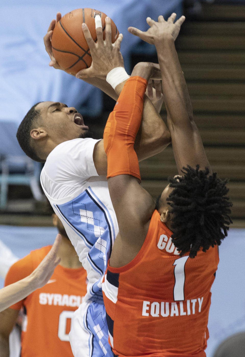 North Carolina's Garrison Brooks (15) muscles his way to the basket against Syracuse's Quincy Guerrier (1) during the first half of an NCAA college basketball game Tuesday, Jan. 12, 2021, in Chapel Hill, NC. (Robert Willett/The News & Observer via AP)