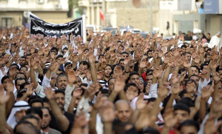 Saudi men march in the mainly Shiite coastal town of Qatif on May 23, 2015, to condemn the attack on a Shiite mosque which left 21 people dead