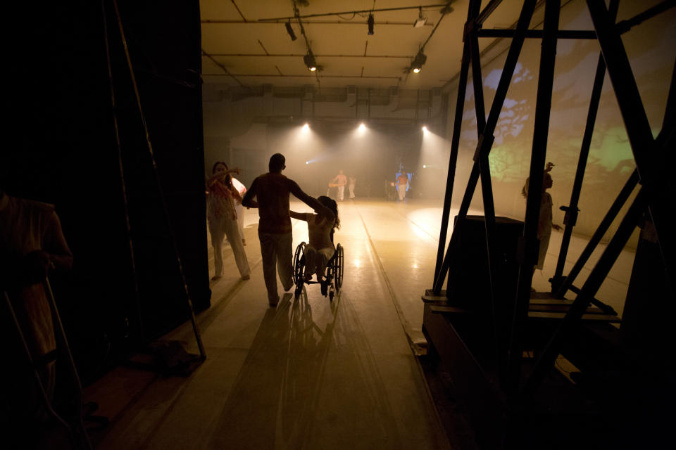 In this Dec. 4, 2018 photo, dancers take the stage to perform in the contemporary dance production Ubuntu, at the Teresa Carreno Theater in Caracas, Venezuela. During the show, disabled dancers perform alongside fully abled professional dancers to demonstrate that art knows no barriers. (AP Photo/Fernando Llano)