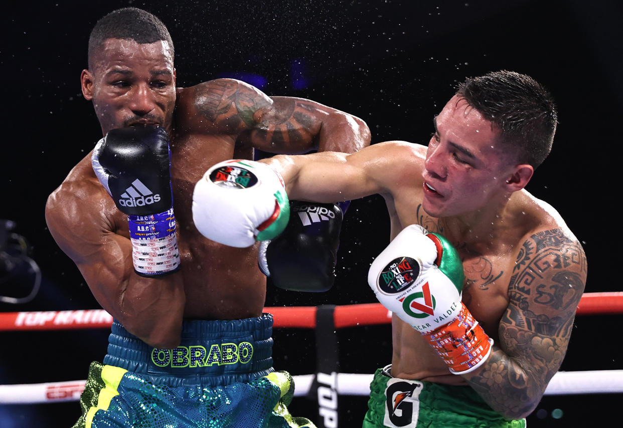 Robson Conceicao (L) and Oscar Valdez (R) exchange punches during their fight for the WBC super featherweight championship at Casino del Sol on Sept. 10, 2021 in Tucson, Arizona. (Photo by Mikey Williams/Top Rank Inc via Getty Images)
