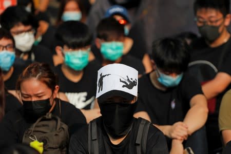 Alumni of Tsuen Wan Public Ho Chuen Yiu Memorial College participate in a student gathering in the school in solidarity with the student protester who was shot by a policeman on Tuesday in Tsuen Wan