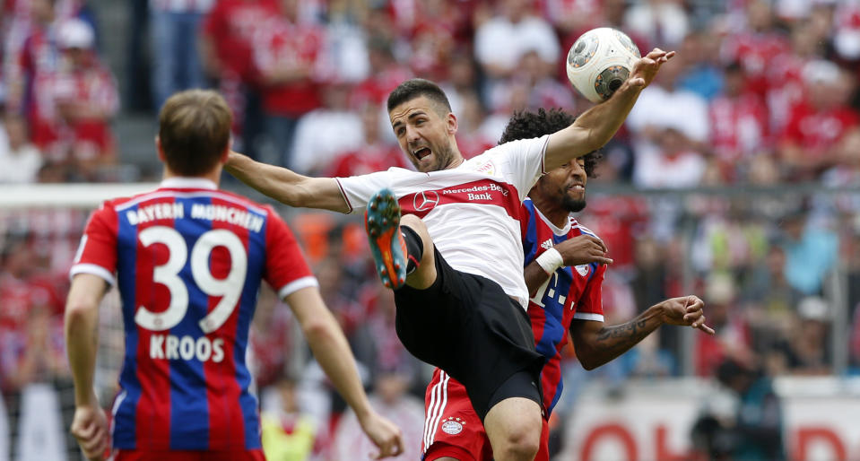Stuttgart's Vedad Ibisevic of Bosnia, foreground, and Bayern's Dante of Brazil challenge for the ball during the German first division Bundesliga soccer match between FC Bayern Munich and VfB Stuttgart, in Munich, southern Germany, Saturday, May 10, 2014. (AP Photo/Matthias Schrader)