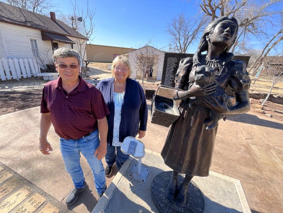 Terri and Lee Veeser pulled over to see the Oz sights in Liberal during their cross-country road trip back to their home in Wisconsin. Dorothy's House, left, and the Land of Oz, back, can be seen behind them.