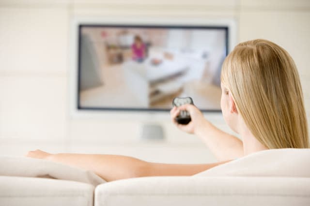 B3F7RH Woman in living room watching television