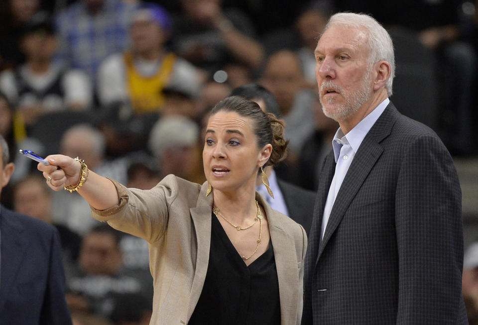 Becky Hammon, then a San Antonio Spurs assistant coach, talks to head coach Gregg Popovich during an NBA game in 2016. (AP Photo/Darren Abate, File)