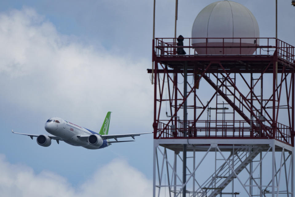 A China's COMAC C919 aircraft flies during the first day of the Singapore Airshow in Singapore, Tuesday, Feb. 20, 2024. (AP Photo/Vincent Thian)