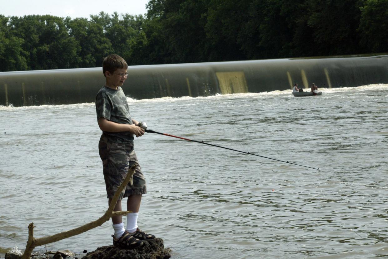 David Kluender fishes near the Williams Dam along the East Fork of the White River during a fishing derby in 2009.