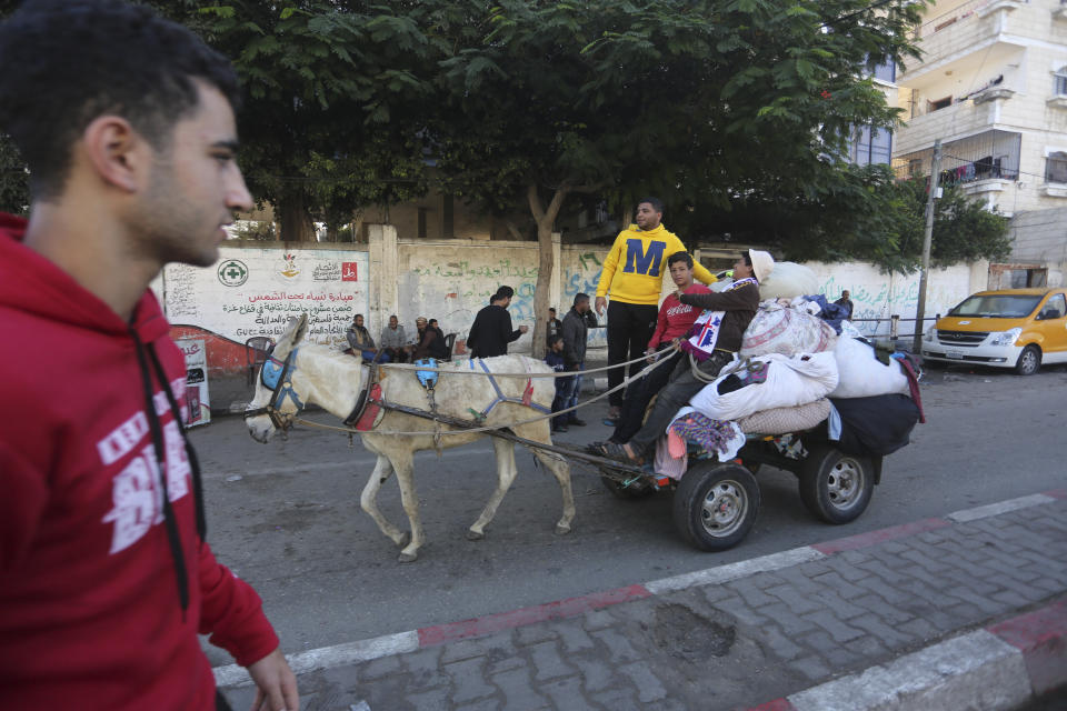 Palestinians ride on a donkey cart in Rafah, Gaza Strip, Thursday, Nov. 16, 2023. (AP Photo/Hatem Ali)