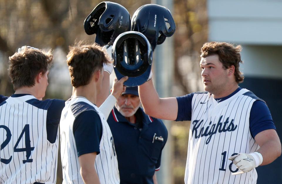 Central Catholic Knights T.J. Bell (18) celebrates with teammates after hitting a homer during the IHSAA baseball game against the Benton Central Bison, Tuesday, April 11, 2023, at Central Catholic High School in Lafayette, Ind. Central Catholic won 8-6.
