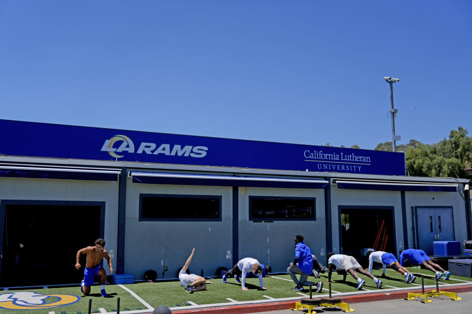 The Los Angeles Rams stretch during an NFL football practice Tuesday, June 11, 2024, in Thousand Oaks, Calif. (AP Photo/Ryan Sun)