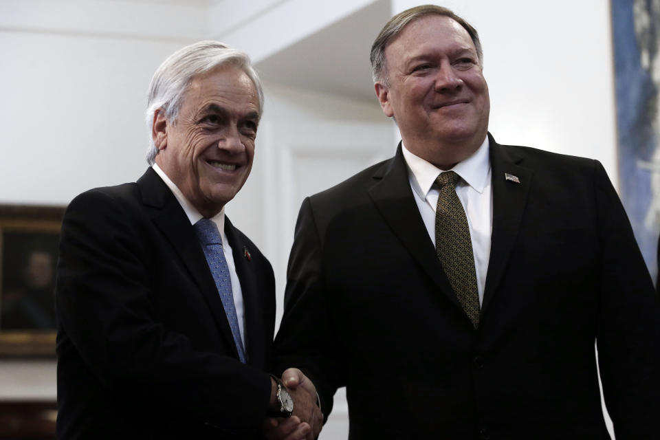 Chile's President Sebastian Piñera and U.S. Secretary of State Mike Pompeo, pose for photos at La Moneda Palace, in Santiago, Chile, Friday, April 12, 2019. Pompeo met Friday with Piñera to address, mainly, the vast crisis that afflicts Venezuela in the first round of a tour that includes Paraguay, Peru and Colombia. (AP Photo/Luis Hidalgo)