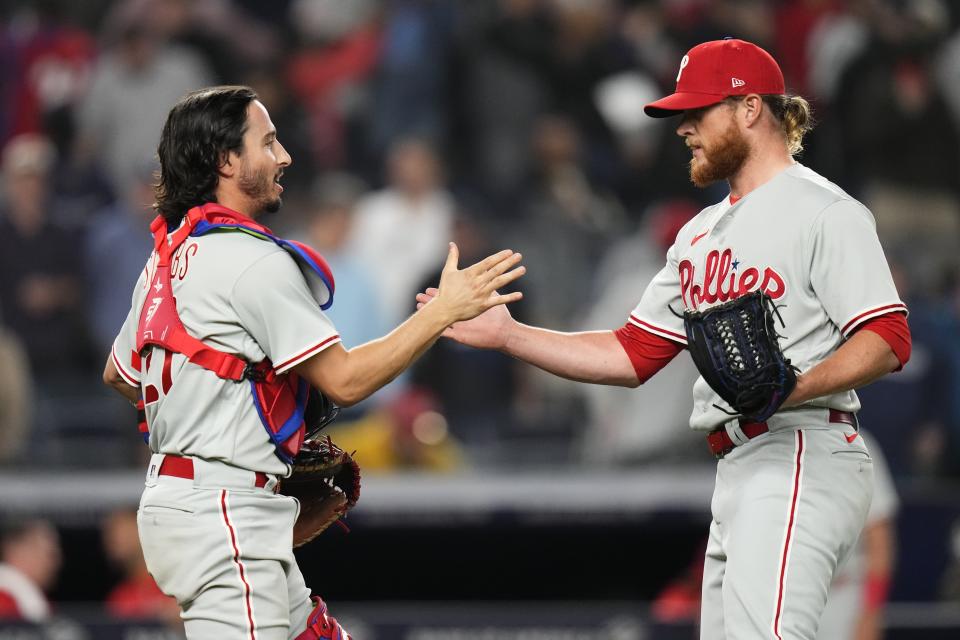 Philadelphia Phillies relief pitcher Craig Kimbrel, right, celebrates with Garrett Stubbs after a baseball game Tuesday, April 4, 2023, in New York. The Phillies won 4-1. (AP Photo/Frank Franklin II)