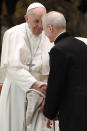 Pope Francis shakes hands with Monsignor Luis Maria Rodrigo Ewart as he arrives in the Paul VI Hall at the Vatican for his weekly general audience, Wednesday, Oct. 28, 2020. A Vatican official who is a key member of Francis' COVID-19 response commission, the Rev. Augusto Zampini, acknowledged Tuesday that at age 83 and with part of his lung removed after an illness in his youth, Francis would be at high risk for complications if he were to become infected. Zampini said he hoped Francis would don a mask at least when he greeted people during the general audience. "We are working on that," he said. (AP Photo/Alessandra Tarantino)