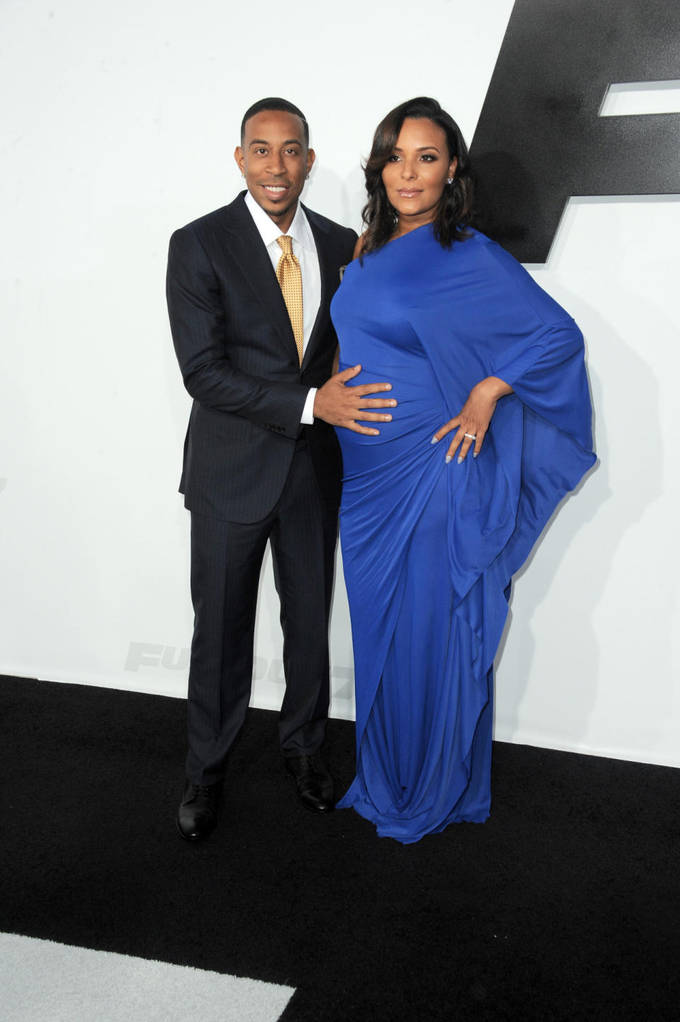 Ludacris, the King of Instagram and “Furious 7” actor, showed his star power off with a gold tie. His fiancé, Eudoxie Mbouguiengue, dressed her baby bump well in a royal blue draped gown, accessorized with the rapper’s constant hand presence.