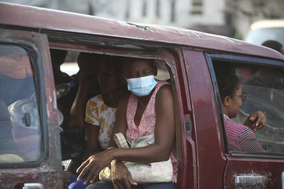 Passengers are transported in a mini-bus in Port-au-Prince, Haiti, Wednesday, April 10, 2024. (AP Photo/Odelyn Joseph)