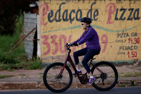 Brazil's President Dilma Rousseff rides her bicycle near the Alvorada Palace in Brasilia, Brazil April 15, 2016. REUTERS/Ueslei Marcelino