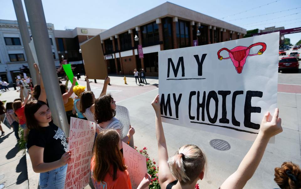 A few hundred people lined the Park Central Square in Downtown Springfield to protest Missouri's new abortion law that bans abortions at or beyond the eighth week of pregnancy on Friday, May 31, 2019.