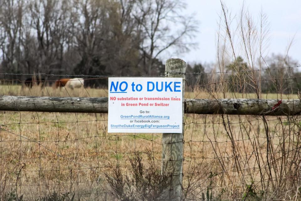 Horses graze behind sign telling residents and passerby to oppose the construction of Duke Energy's new substation in Green Pond, South Carolina.