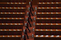 Tea hostesses wearing face masks to help curb the spread of the coronavirus prepare tea for members of the National Committee of the Chinese People's Political Consultative Conference (CPPCC) ahead of the opening session of the CPPCC at the Great Hall of the People in Beijing, Thursday, March 4, 2021. (AP Photo/Andy Wong)