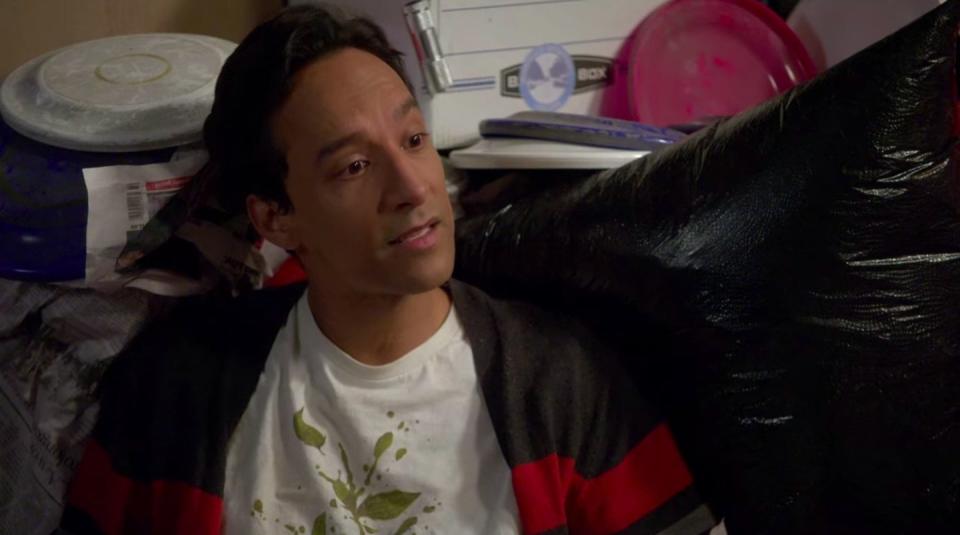 Abed talking while sitting in a supply closet filled with frisbees in "Community"