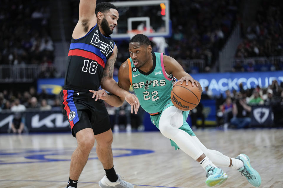 San Antonio Spurs guard Malaki Branham (22) drives on Detroit Pistons guard Cory Joseph (18) in the second half of an NBA basketball game in Detroit, Friday, Feb. 10, 2023. (AP Photo/Paul Sancya)