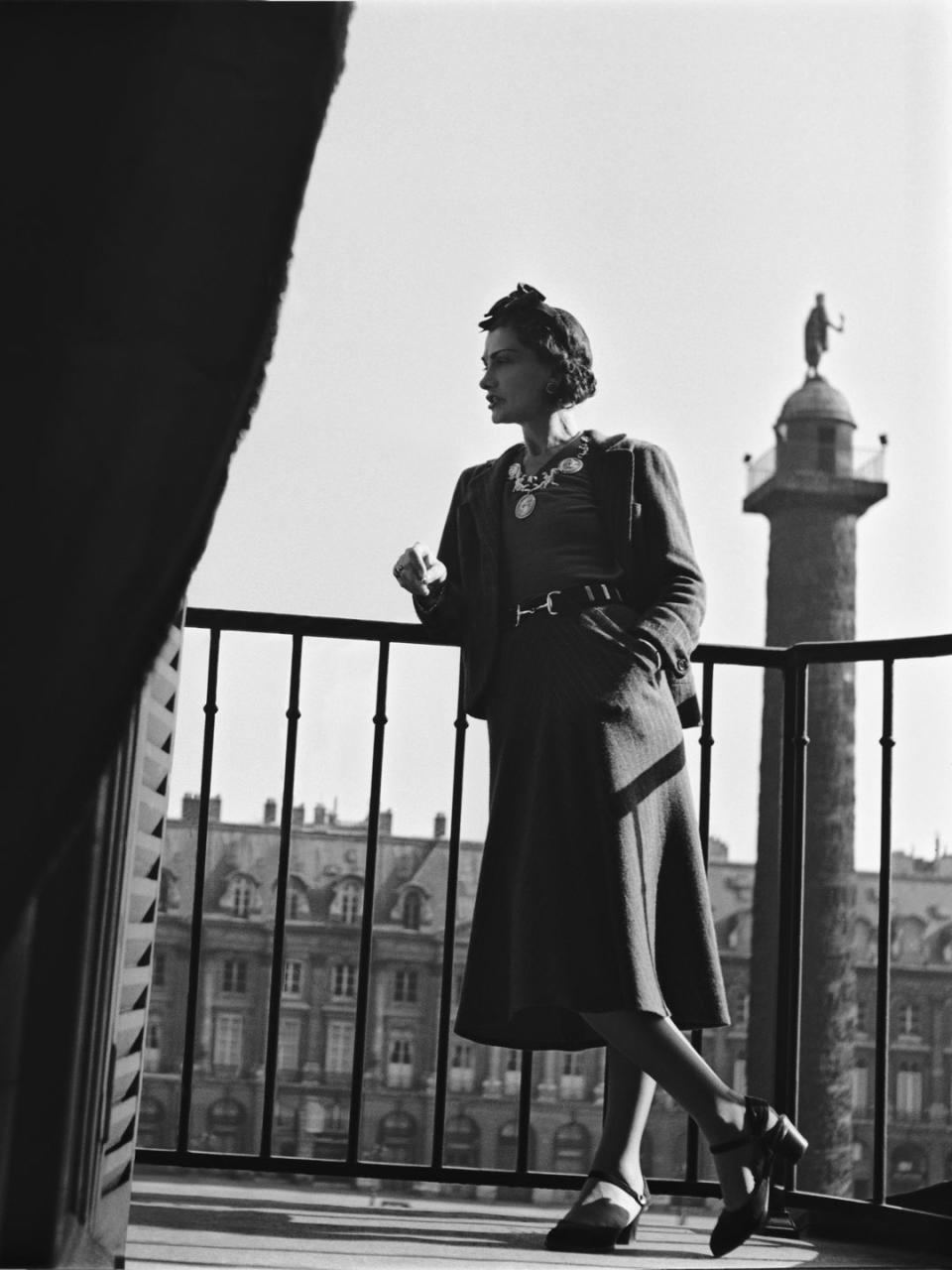 Coco Chanel poses on a balcony in 1937