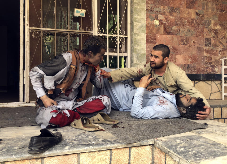 An injured man lies down after a bomb blast in Mazar-e-Sharif, the capital city of Balkh province, in northern Afghanistan, Saturday, March 11, 2023. A bomb exploded on Saturday during an award ceremony for journalists in the city. (AP Photo/Abdul Saboor Sirat)