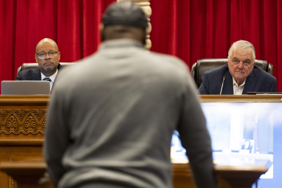 Nevada Attorney General Aaron Ford, left, and Gov. Steve Sisolak, listen to former Nevada death row inmate James Allen, speaking in favor of an incarcerated man during a pardons board meeting at the Nevada Supreme Court in Las Vegas, Tuesday, Dec. 20, 2022. (Erik Verduzco/Las Vegas Review-Journal via AP)