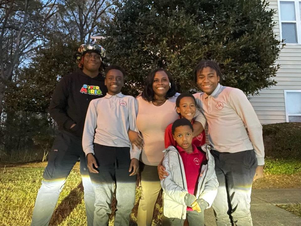 Shanice Geiger, center, with her children. From left, Zion, age 15, Kaleb, age 12, Christian, age 9, Ayden, 5 and Zachary, 13. Not pictured is Nadya, age 17. The family is receiving holiday presents thanks to the Observer’s Empty Stocking Fund and the Salvation Army’s Angel Tree program.