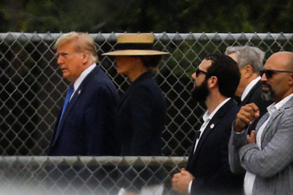 Former U.S. President Donald Trump walks with his wife Melania, as they attend the graduation ceremony of their son Barron Trump, in West Palm Beach, Florida, U.S. May 17, 2024 (Reuters)