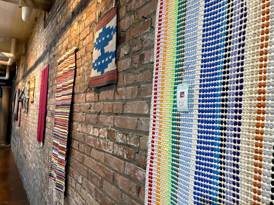 Some of the pieces created by the Des Moines Weavers and Spinners Guild on display in The Cellar at La Poste ahead of the Fiber Festival of Perry.