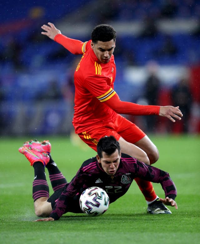 Wales’ Ben Cabango (right) jostles with Mexico’s Hirving Lozano and after the game he was subjected to racial abuse on social media (PA).