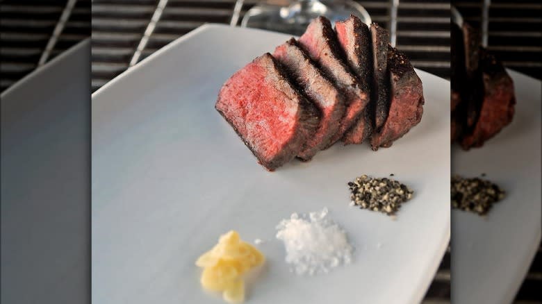 sliced sous vide steak and seasonings