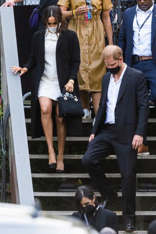 <p>Gotham/GC Images</p> Meghan Markle and Prince Harry leave the the Global Citizen concert in Central Park on September 25, 2021 in New York City.