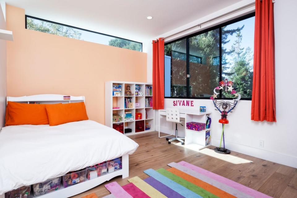 <p>A peach accent wall adds life to this children's room by <a href="http://www.maydanarchitects.com/" rel="nofollow noopener" target="_blank" data-ylk="slk:Maydan Architects;elm:context_link;itc:0;sec:content-canvas" class="link ">Maydan Architects</a>. </p>