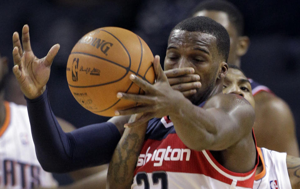 Washington Wizards' Shelvin Mack, front, is fouled by Charlotte Bobcats' Tyrus Thomas, back, during the second half of an NBA basketball game in Charlotte, N.C., Monday, April 9, 2012. Washington won 113-85. (AP Photo/Chuck Burton)